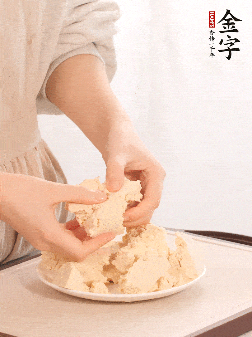 老豆腐用手掰成塊。